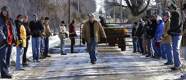 Alan Yegerlehner, center, reminds his volunteers to keep the lines taut as they prepare to move Yegerlehner’s cattle to their winter pasture Saturday in rural Clay County near Clay City. Joseph C. Garza | Terre Haute Tribune-Star, Associated Press